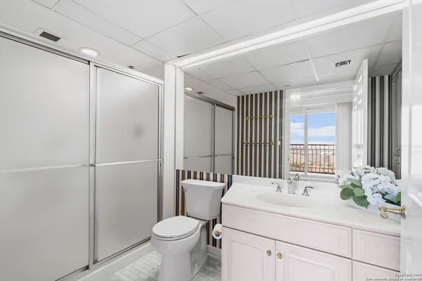 a bathroom with a sink toilet and shower