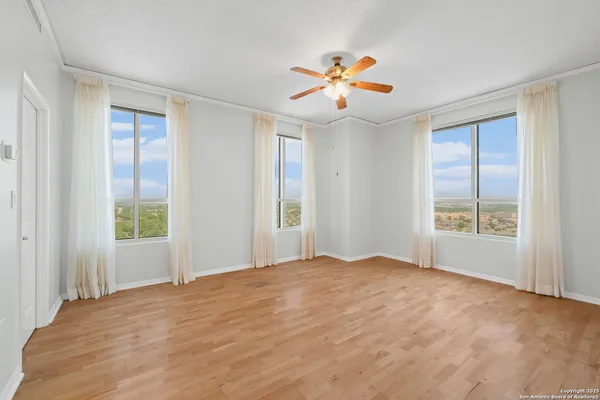 a view of an empty room with window and closet area