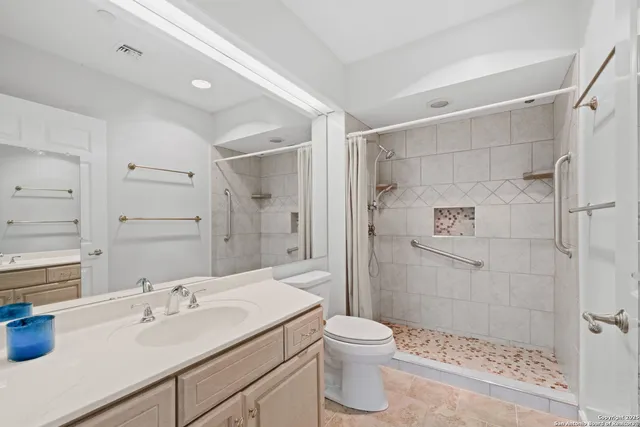 a bathroom with a sink toilet and shower