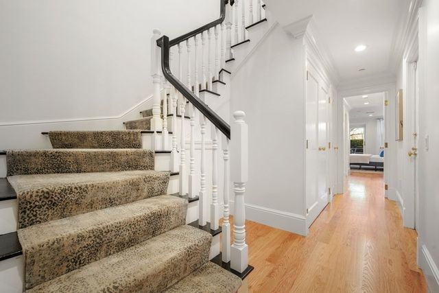 a view of entryway and hall with wooden floor