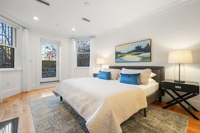 a bedroom with a large bed and a window