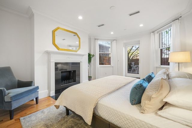 a bed room with a bed a couch and a lamp