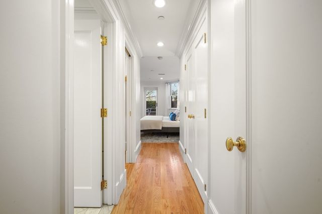 a view of a hallway with wooden floor and staircase