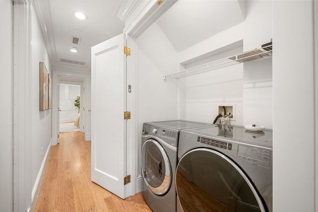 a view of a storage & utility room with dryer and washer