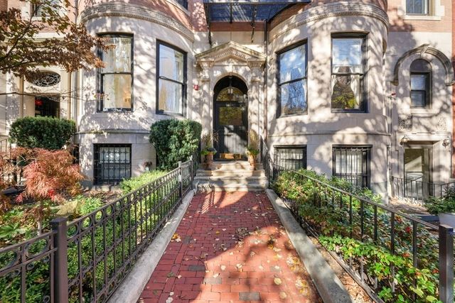 a front view of a multi story residential apartment building with a yard