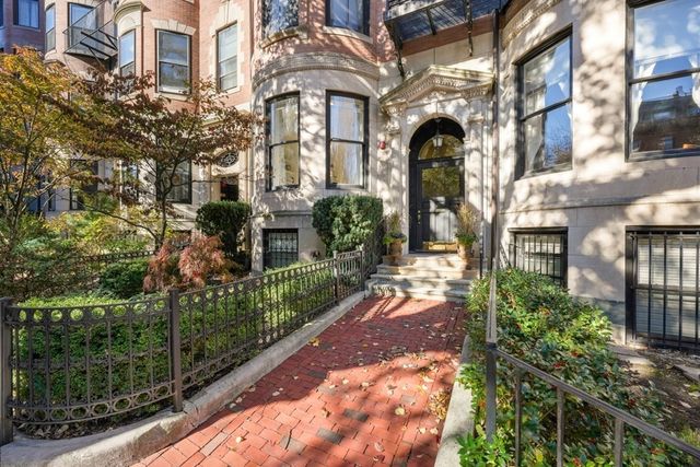 a view of a brick building next to a yard