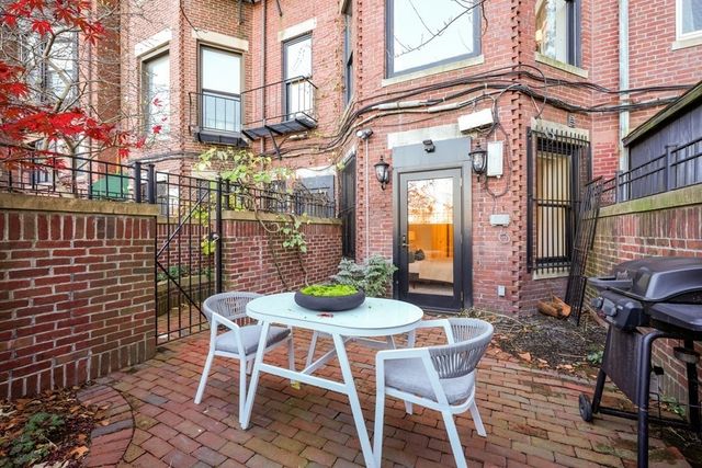 a view of a chairs and table in a patio