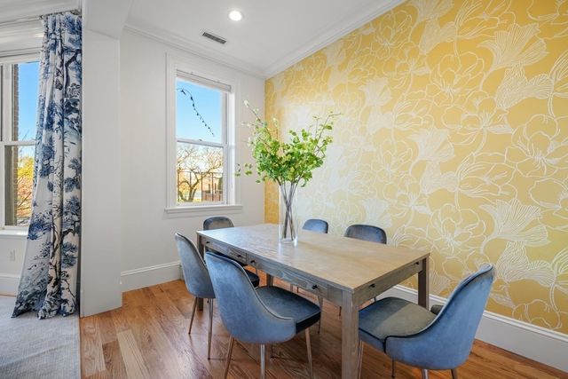 a view of a dining room with furniture and wooden floor