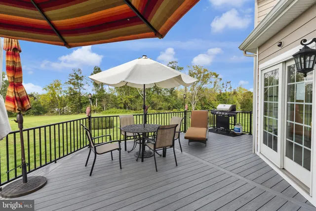 a view of a dining room with furniture chandelier and wooden floor