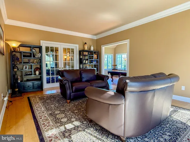 a view of a livingroom with wooden floor and stairs