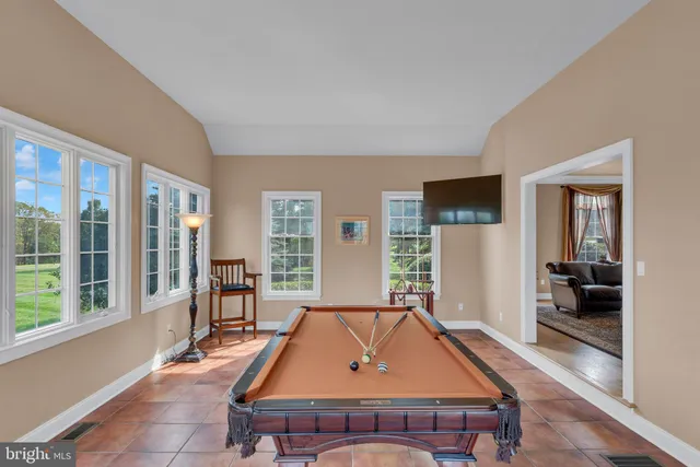 a reading room with furniture a rug and a window