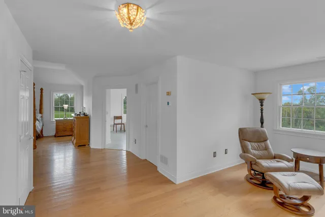 a view of a house with a big yard and a large trees