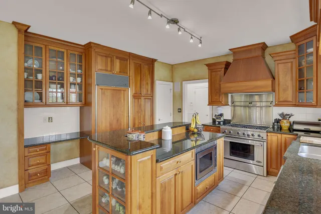 a kitchen with stainless steel appliances granite countertop a sink and cabinets