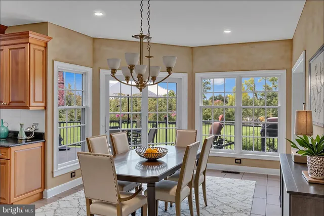 a view of a roof deck with table and chairs