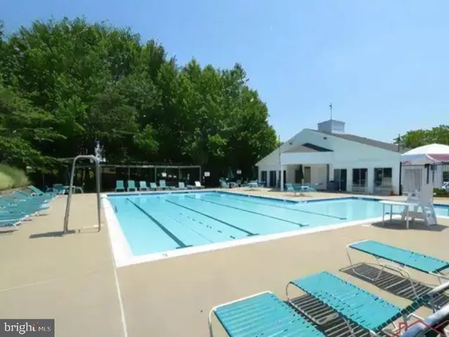 a swimming pool view with outdoor seating
