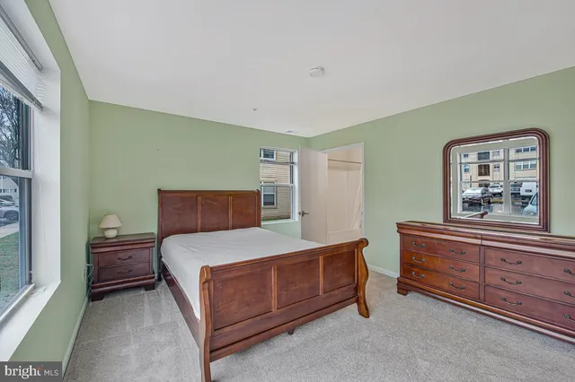 a bathroom with a granite countertop toilet sink and mirror