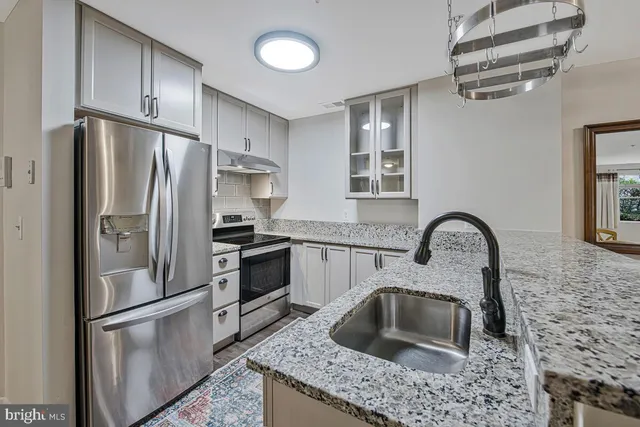 a living room with couches and a hard wood floor