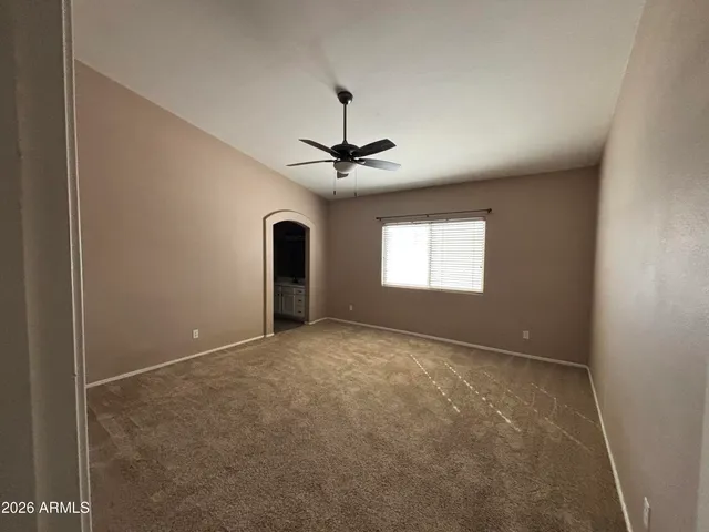 a view of a livingroom with a ceiling fan and window