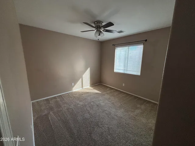 a view of a livingroom with a ceiling fan and window