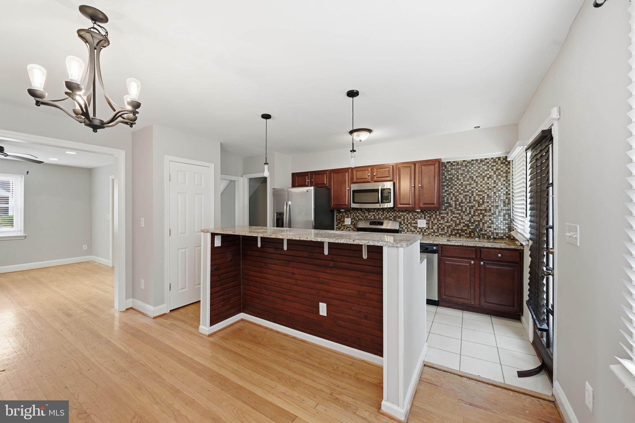 3723 Yolando Road Baltimore, MD 21218 - Photo 11 of 42 a kitchen with stainless steel appliances granite countertop a refrigerator and a sink