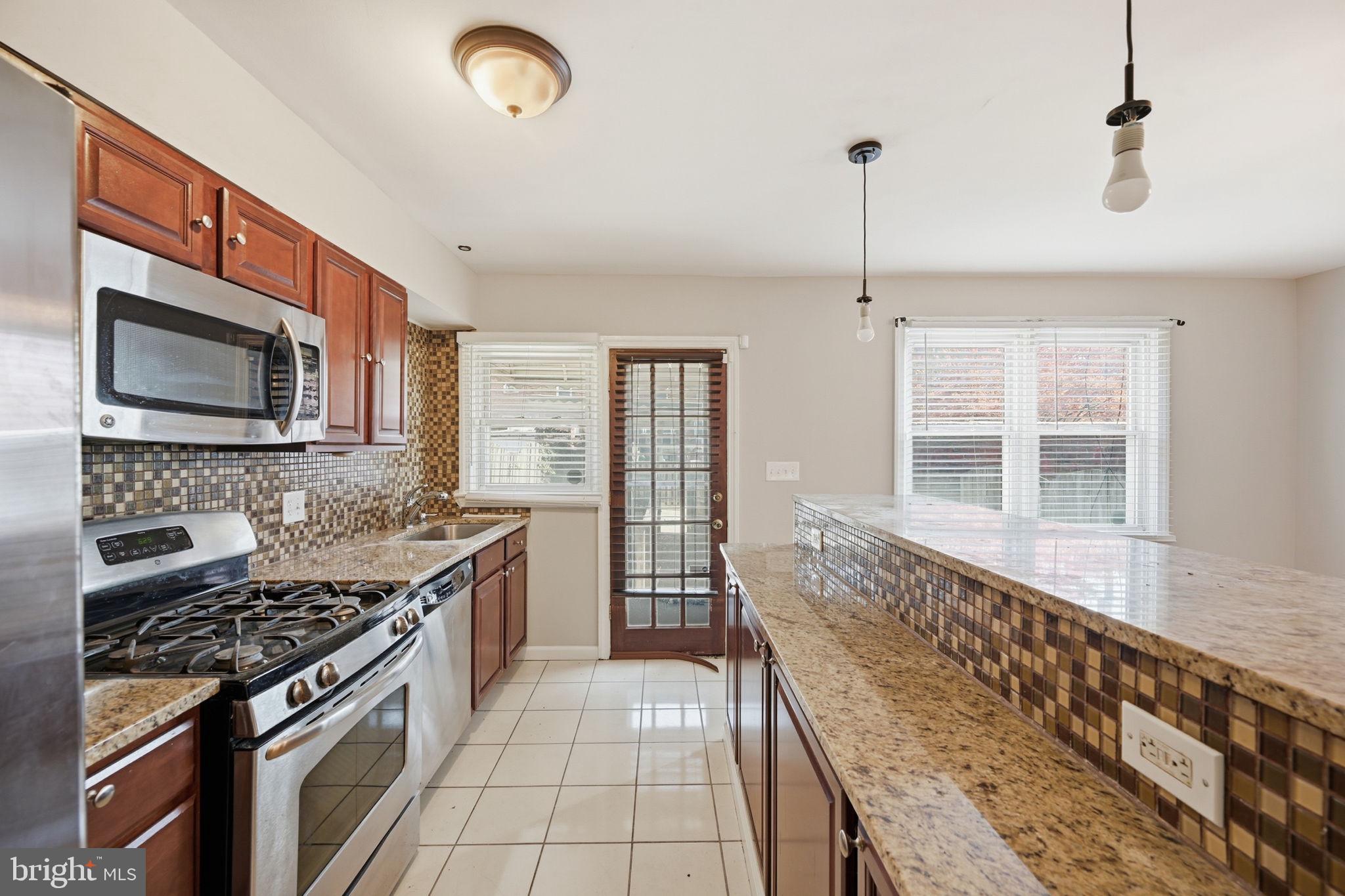 3723 Yolando Road Baltimore, MD 21218 - Photo 13 of 42 a kitchen with a stove and a sink