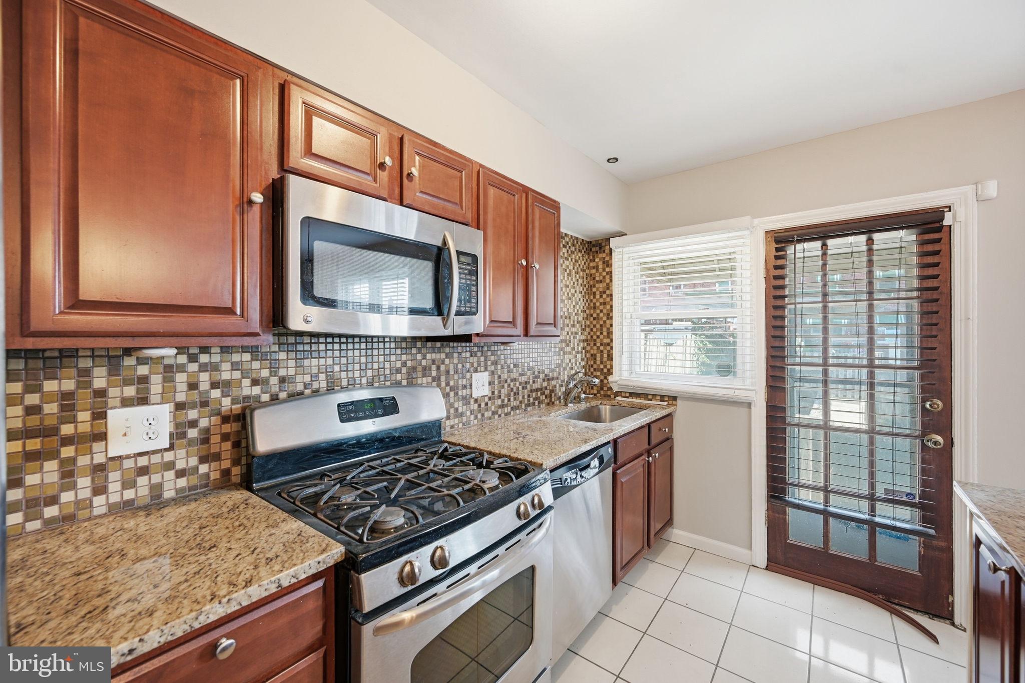 3723 Yolando Road Baltimore, MD 21218 - Photo 14 of 42 a kitchen with a stove and a microwave
