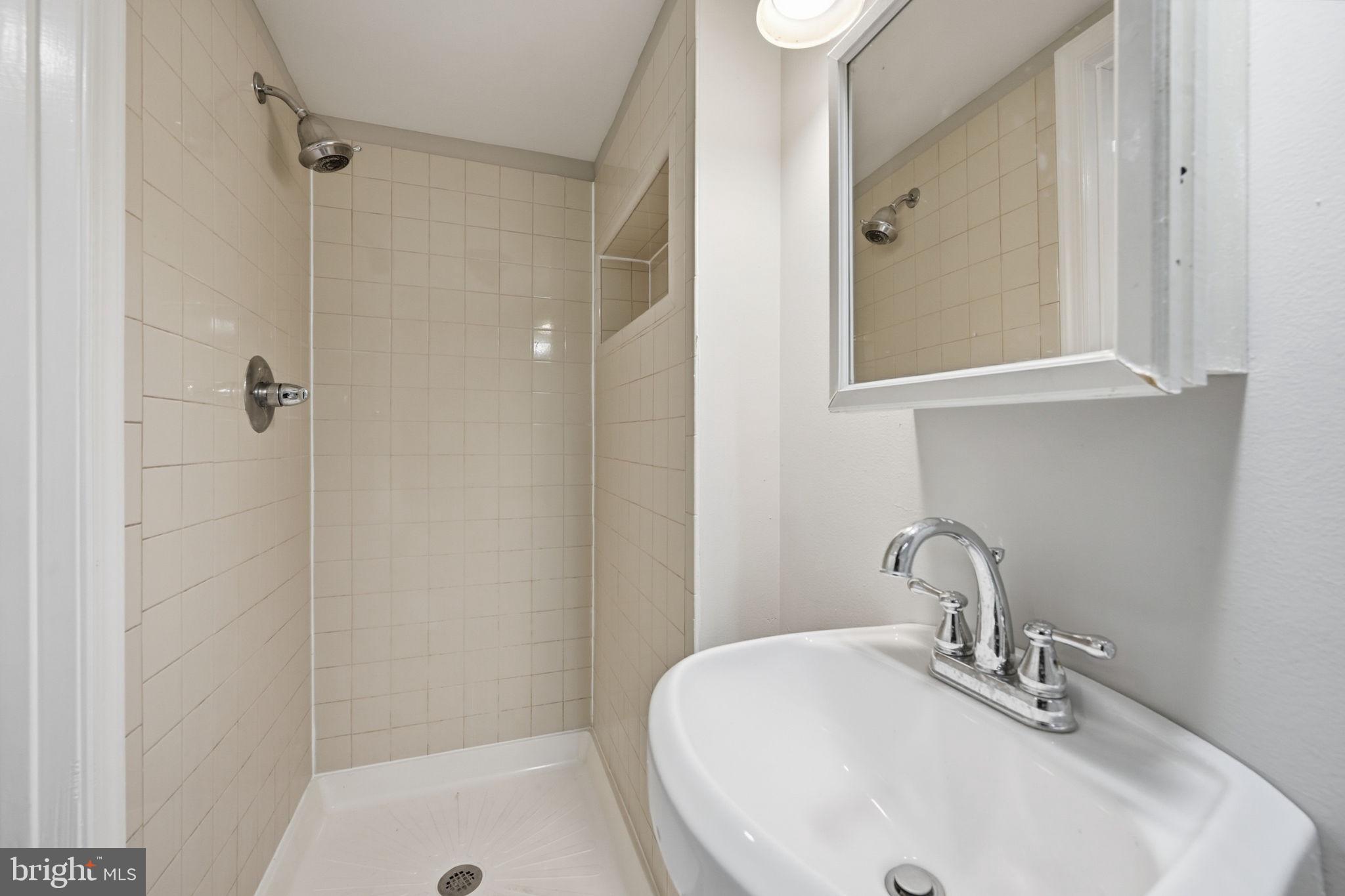 3723 Yolando Road Baltimore, MD 21218 - Photo 23 of 42 a bathroom with a sink and a mirror