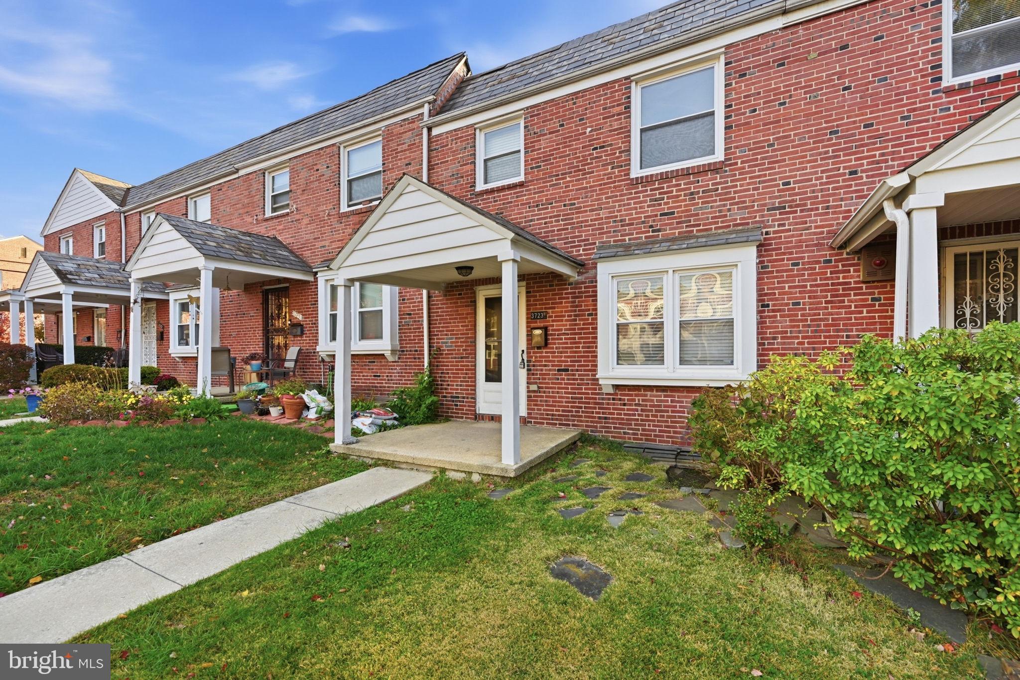 3723 Yolando Road Baltimore, MD 21218 - Photo 4 of 42 a view of a brick house with a yard plants and large tree