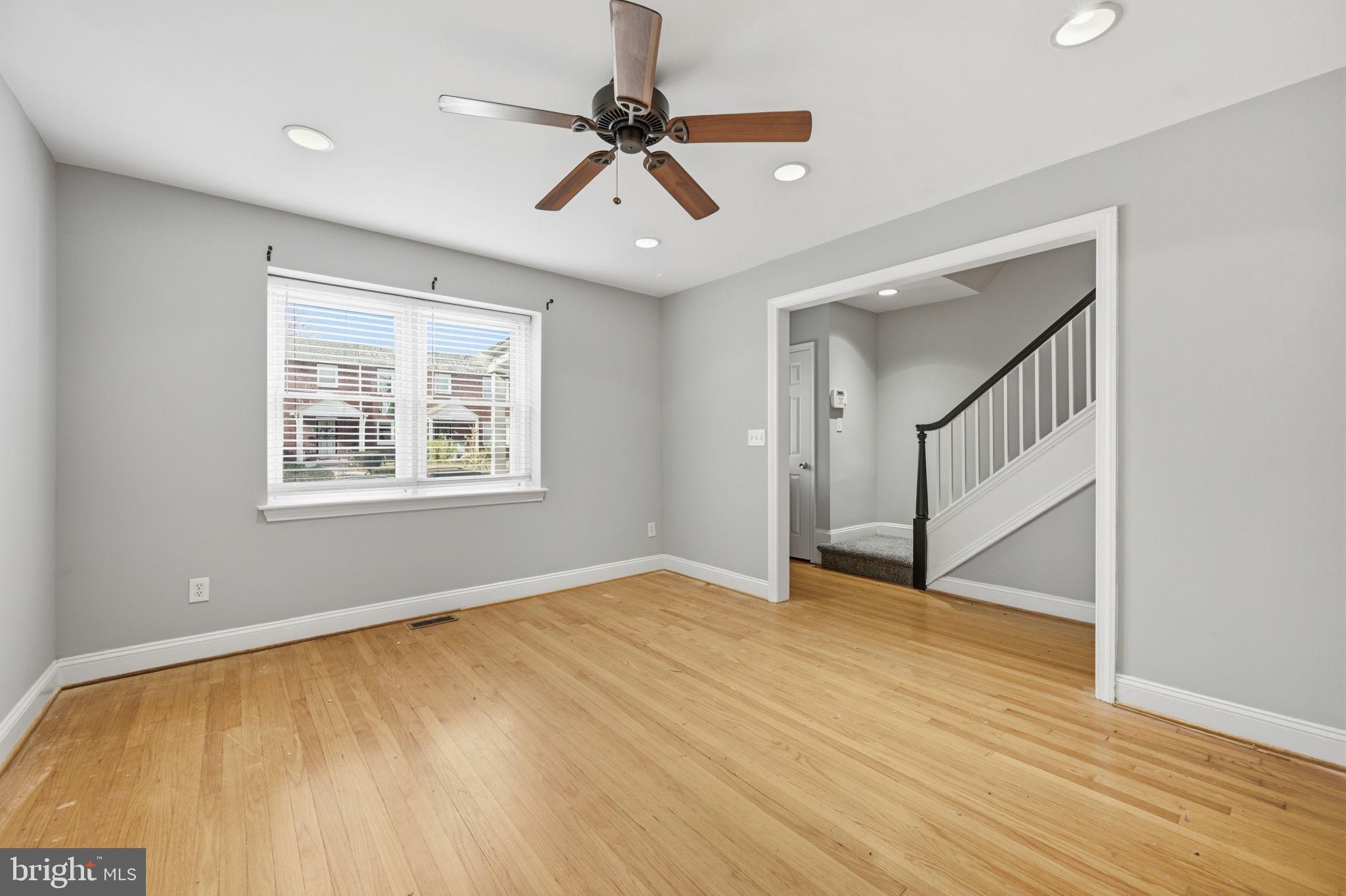 3723 Yolando Road Baltimore, MD 21218 - Photo 5 of 42 a view of an empty room with wooden floor and a window