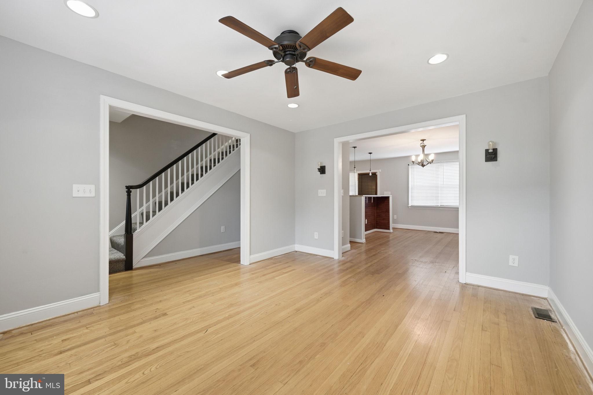3723 Yolando Road Baltimore, MD 21218 - Photo 6 of 42 a view of an empty room with wooden floor and a ceiling fan