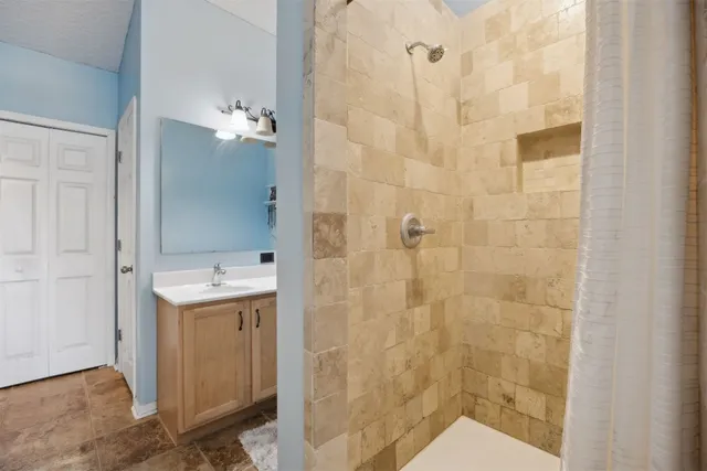 a bedroom with a bed and ceiling fan