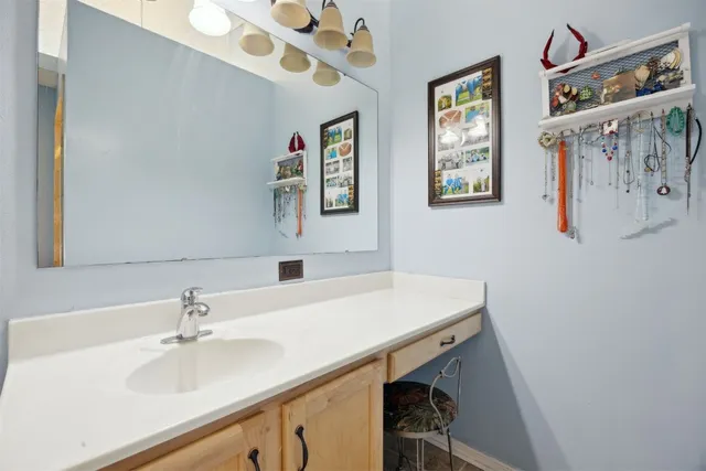 a bedroom with a large bed and a chandelier fan
