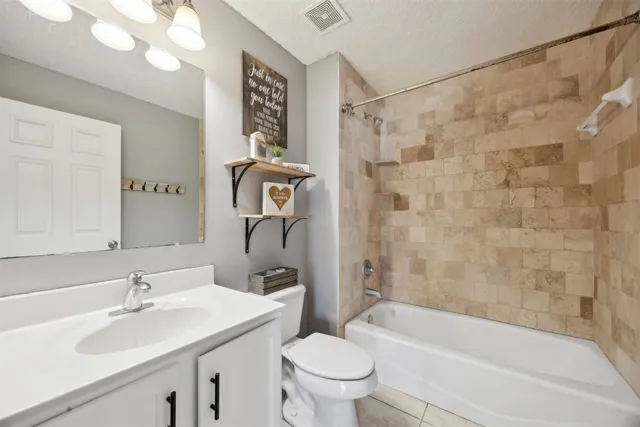 a view of a house with a big yard and large trees