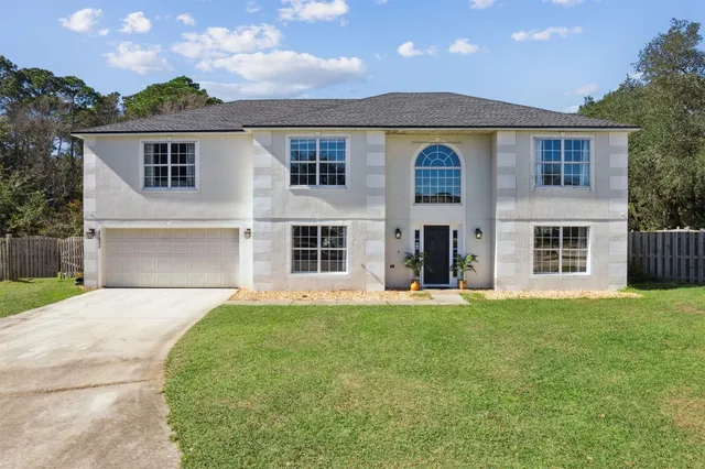 an aerial view of a house with garden space and street view
