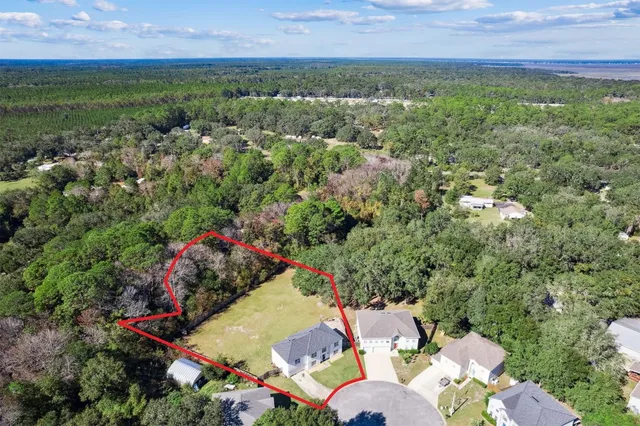 an aerial view of a houses with yard