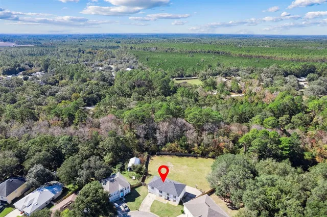 an aerial view of a houses with a yard