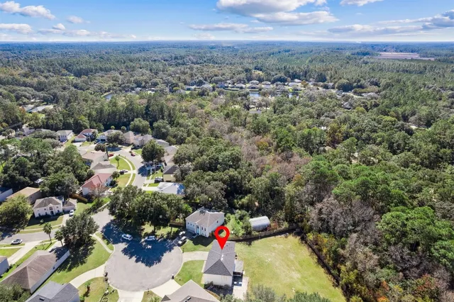 an aerial view of a house with a yard