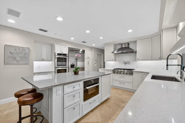 a bedroom with a bed a desk and chair with the wooden floor