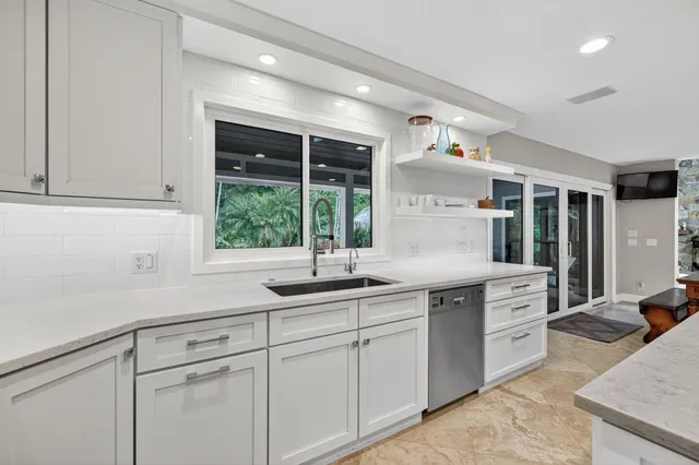 a bathroom with a granite countertop sink mirror vanity and toilet