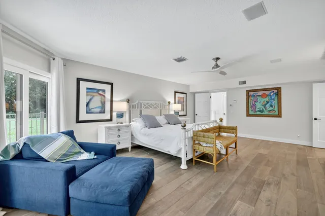 a bedroom with a bed and a chair in it