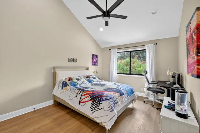 a aerial view of a houses with a lush green forest
