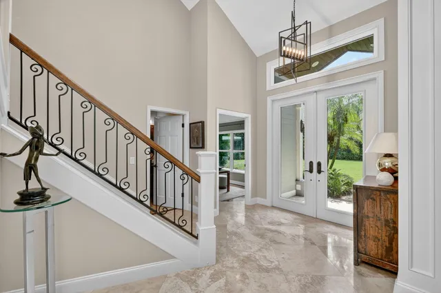 a living room with furniture a large window and a fireplace