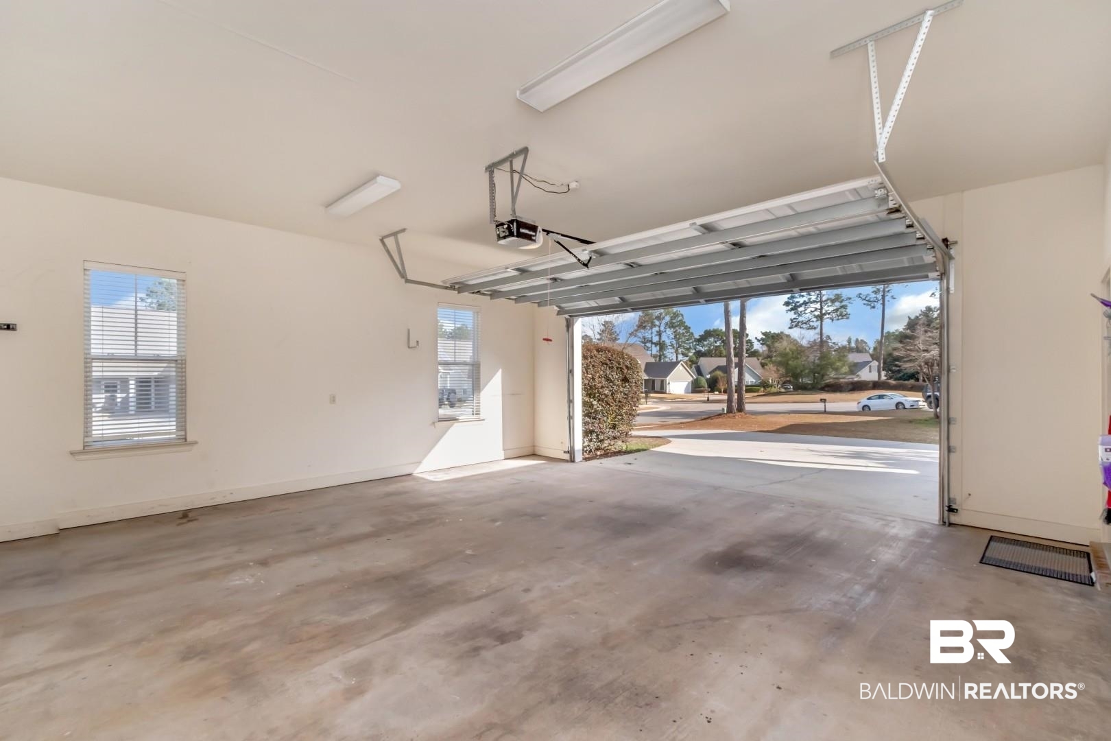30585 Pine Court Daphne, AL 36527 - Photo 45 of 49 Garage featuring baseboards and a garage door opener
