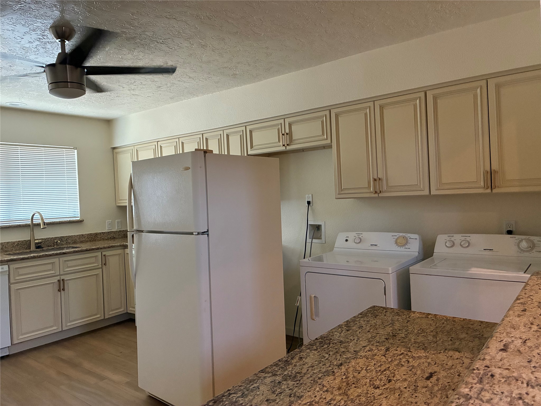 6401 Deihl Road, Unit 1011 Houston, TX 77092 - Photo 7 of 16 a kitchen with a sink a refrigerator and cabinets