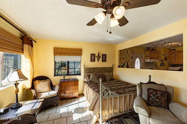 a bedroom with a bed and a table chair