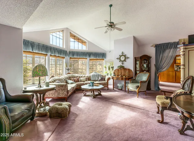 a kitchen that has a sink a stove and chairs