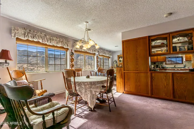 a view of a hallway to a livingroom with wooden floor and a bathroom