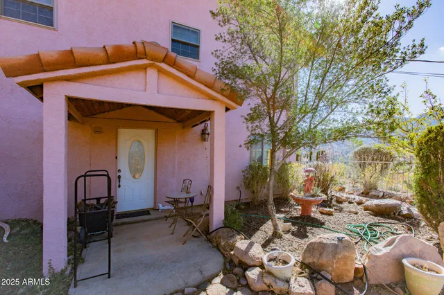 a view of a porch with plants and trees