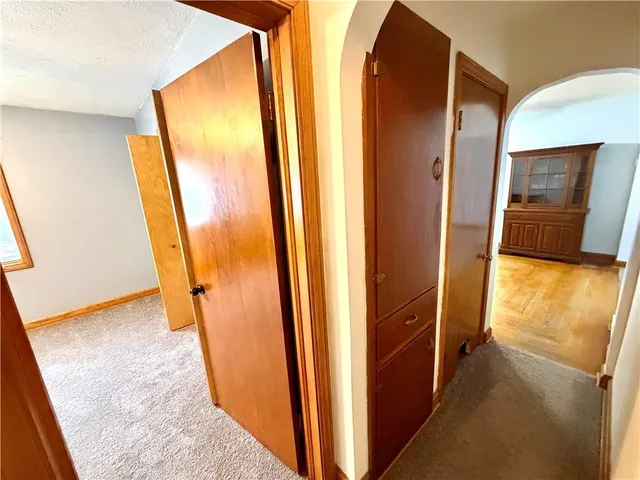 an empty room with closet and a chandelier fan