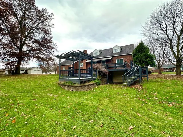 a front view of a house with a garden and plants